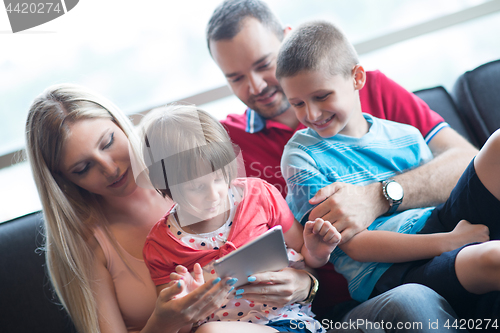 Image of happy young couple spending time with kids