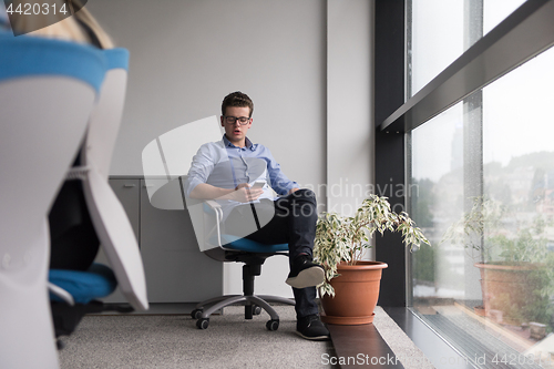 Image of businessman in startup office by the window