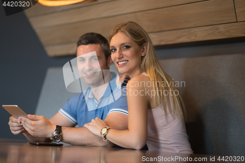 Image of couple using tablet at home