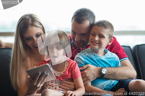 Image of happy young couple spending time with kids
