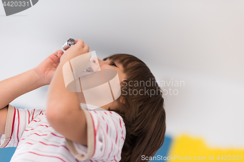 Image of kid blowing a noisemaker