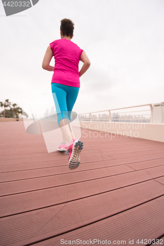 Image of woman running on the promenade