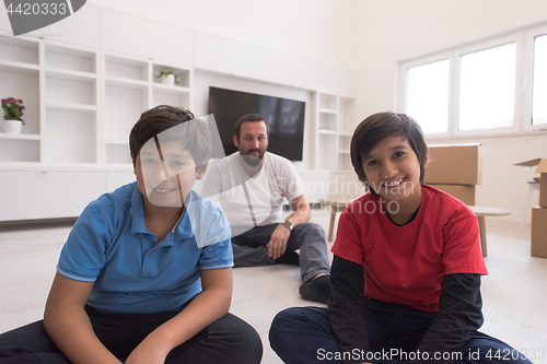 Image of portrait of happy young boys with their dad