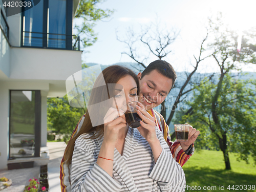 Image of Young beautiful couple in bathrobes