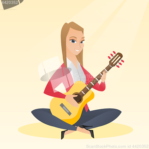 Image of Woman playing the acoustic guitar.