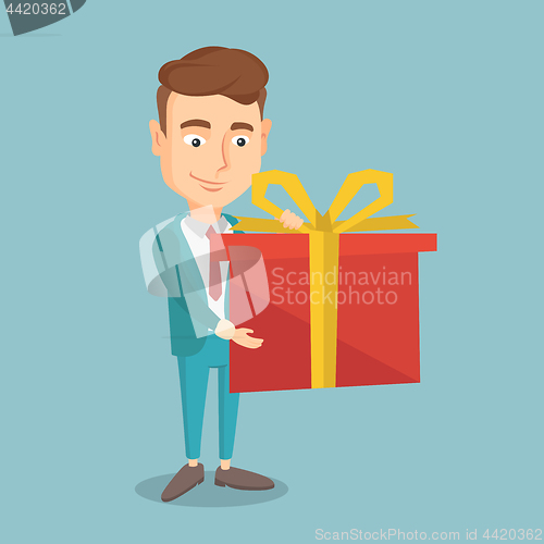 Image of Joyful caucasian wman holding box with gift.