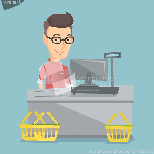 Image of Cashier standing at the checkout in a supermarket.