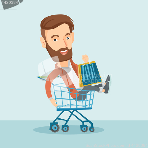 Image of Happy man riding in shopping trolley.