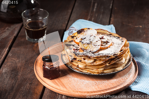 Image of Fresh homemade french crepes made with eggs, milk and flour, filled with marmalade on a vintage plate