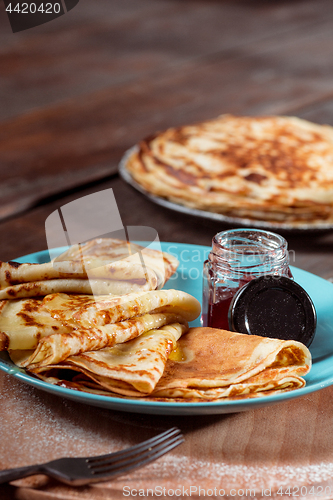 Image of Fresh homemade french crepes made with eggs, milk and flour, filled with marmalade on a vintage plate