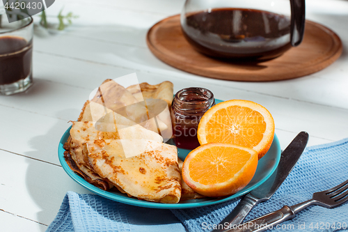 Image of Fresh homemade french crepes made with eggs, milk and flour, filled with marmalade on a vintage plate