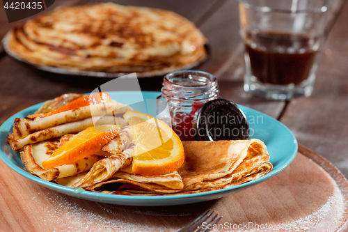 Image of Fresh homemade french crepes made with eggs, milk and flour, filled with marmalade on a vintage plate