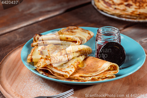 Image of Fresh homemade french crepes made with eggs, milk and flour, filled with marmalade on a vintage plate