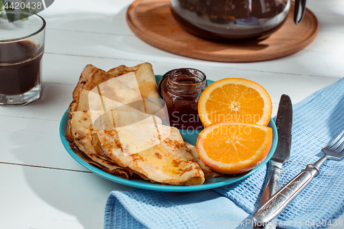 Image of Fresh homemade french crepes made with eggs, milk and flour, filled with marmalade on a vintage plate