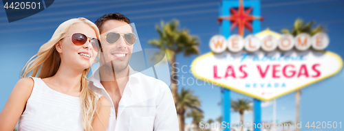 Image of couple in shades over las vegas sign at summer