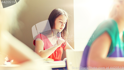 Image of group of students with books writing school test