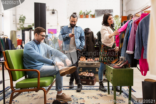 Image of friends choosing clothes at vintage clothing store