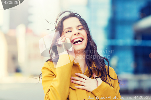 Image of smiling young woman or girl calling on smartphone