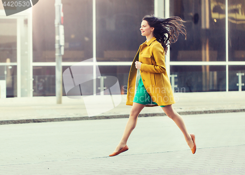 Image of happy young woman or teenage girl on city street