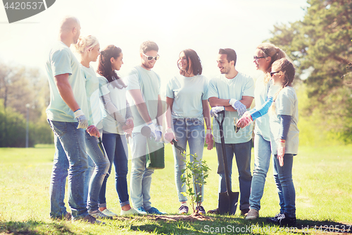 Image of group of volunteers planting tree in park