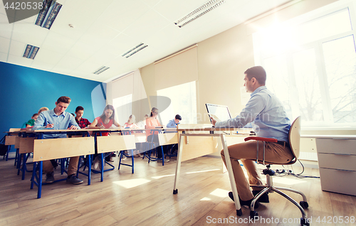 Image of students and teacher with tablet pc at school