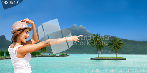 Image of happy young woman in hat on bora bora beach