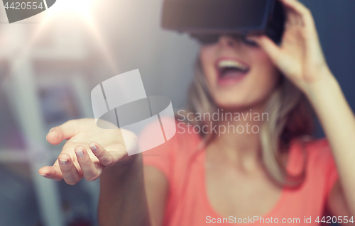 Image of happy woman in virtual reality headset or glasses