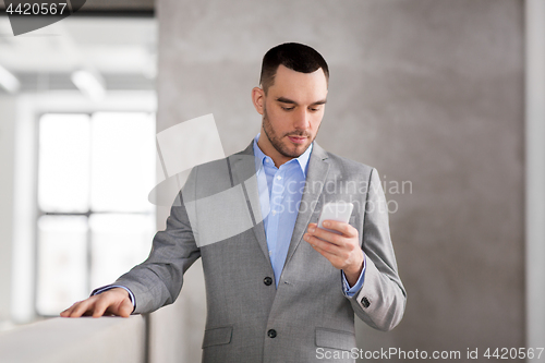 Image of businessman with smarphone at office