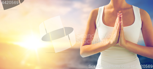 Image of close up of woman making greeting gesture outdoors