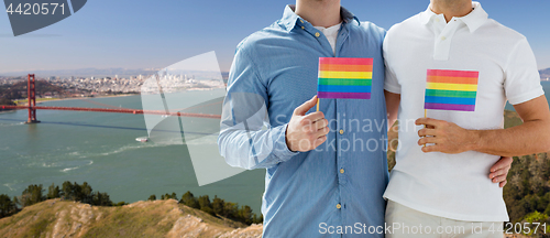 Image of men with gay pride flags over golden gate bridge