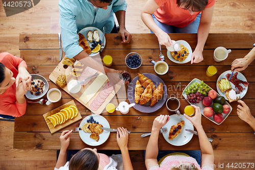 Image of group of people having breakfast at table