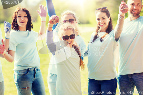 Image of group of volunteers celebrating success in park