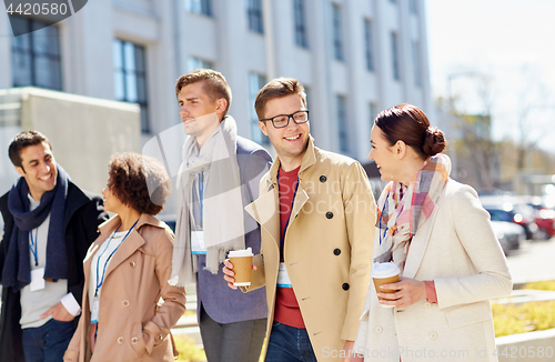 Image of office workers with coffee on city street