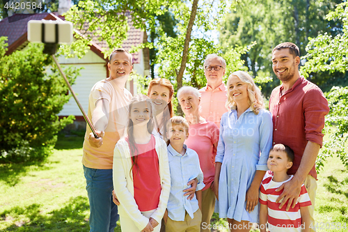 Image of happy family taking selfie in summer garden