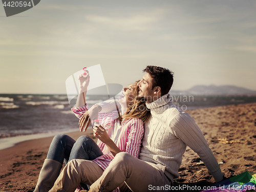 Image of young couple enjoying time together at beach