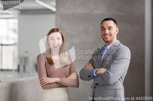 Image of smiling businesswoman and businessman at office
