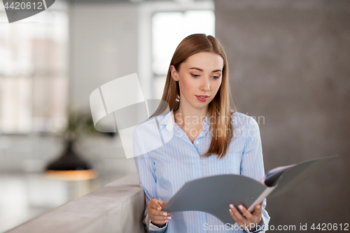 Image of female office worker with folder