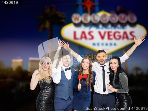 Image of happy friends with party props posing at las vegas