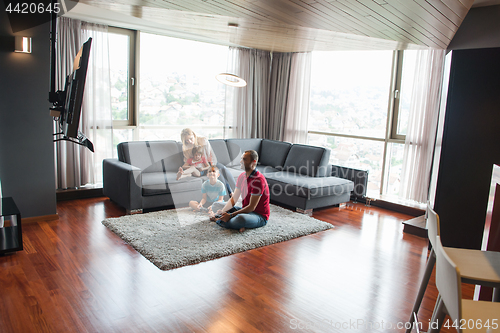 Image of Happy family playing a video game