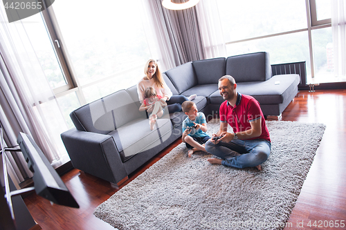 Image of Happy family playing a video game