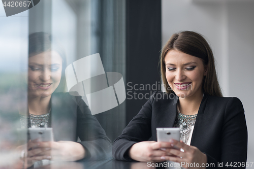 Image of Business Girl Standing In A Modern Building Near The Window With