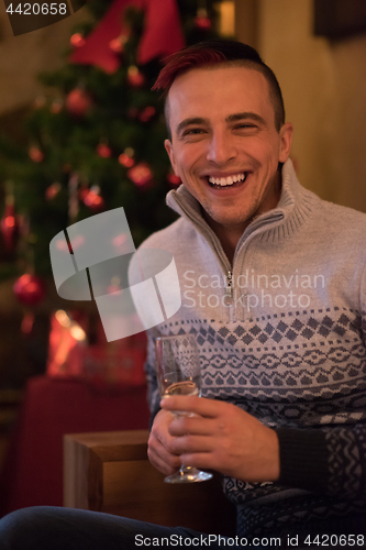 Image of Happy young man with a glass of champagne