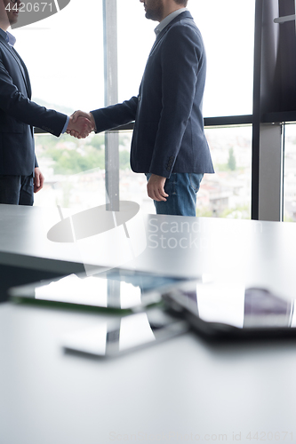 Image of cloasing the deal in modern office interior