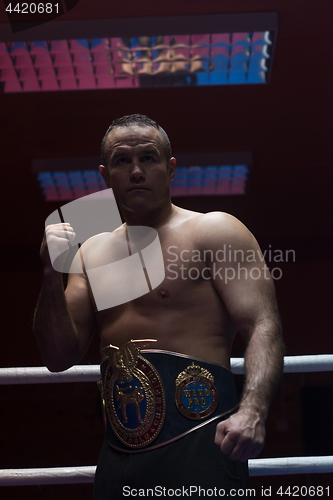 Image of kick boxer with his championship belt