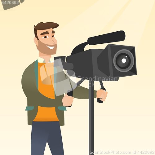 Image of Cameraman with a movie camera on tripod.