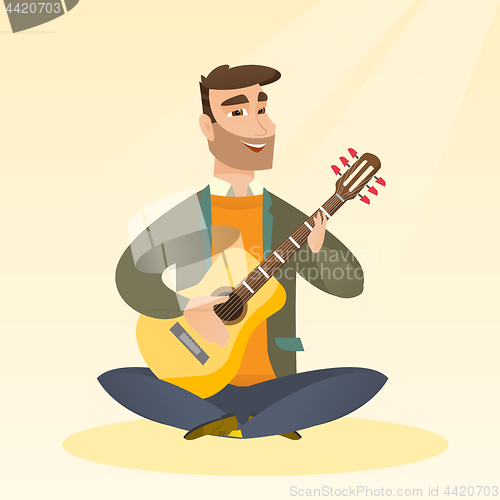 Image of Man playing the acoustic guitar.