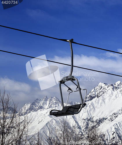 Image of Ski lift in snow winter mountains at nice sun day