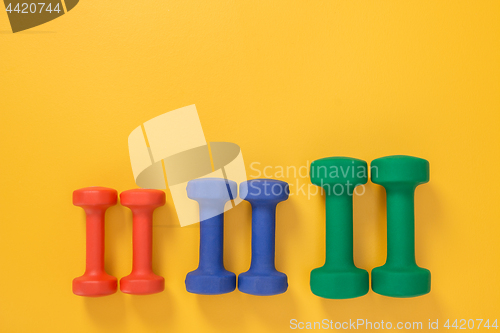 Image of Dumbbells of different colors and sizes