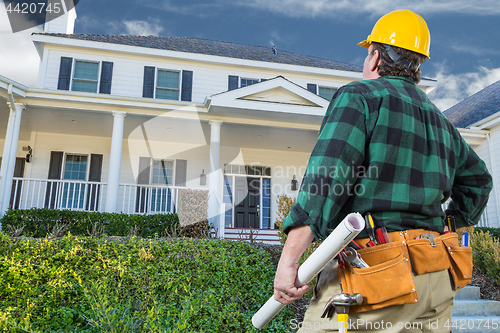 Image of Male Contractor with Hard Hat and Tool Belt Looking At Custom Ho