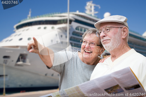 Image of Happy Senior Adult Couple Tourists with Brochure Next To Passeng
